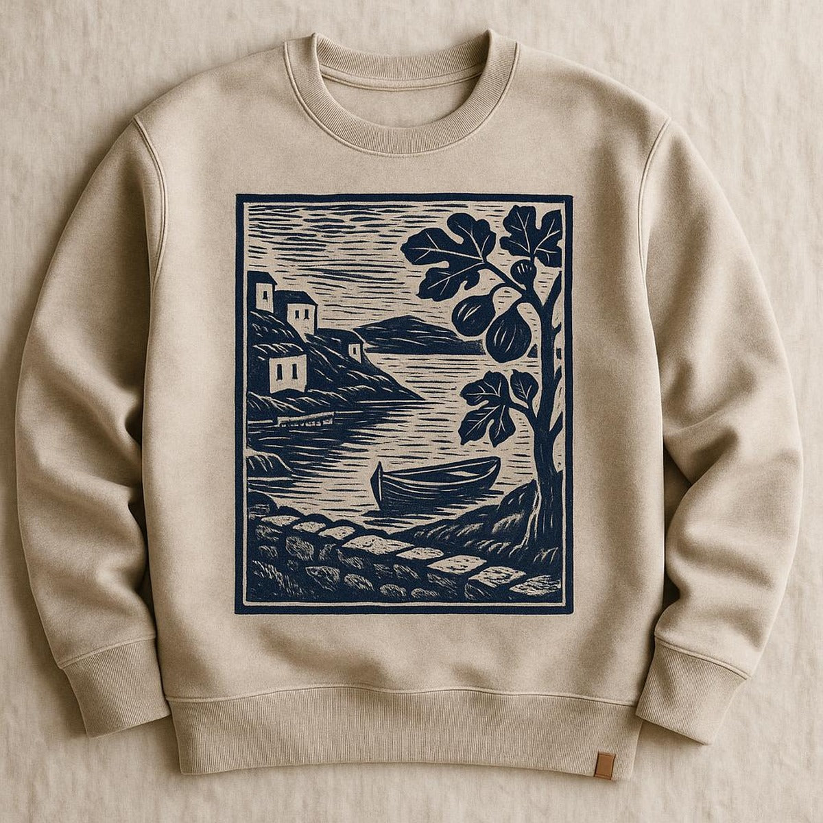 Folded stone beige sweatshirt styled beside figs and linen on a wooden kitchen table