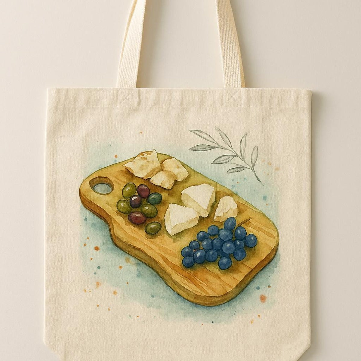 Tote bag resting on a Mediterranean table setting beside olives and shared plates for a long lunch