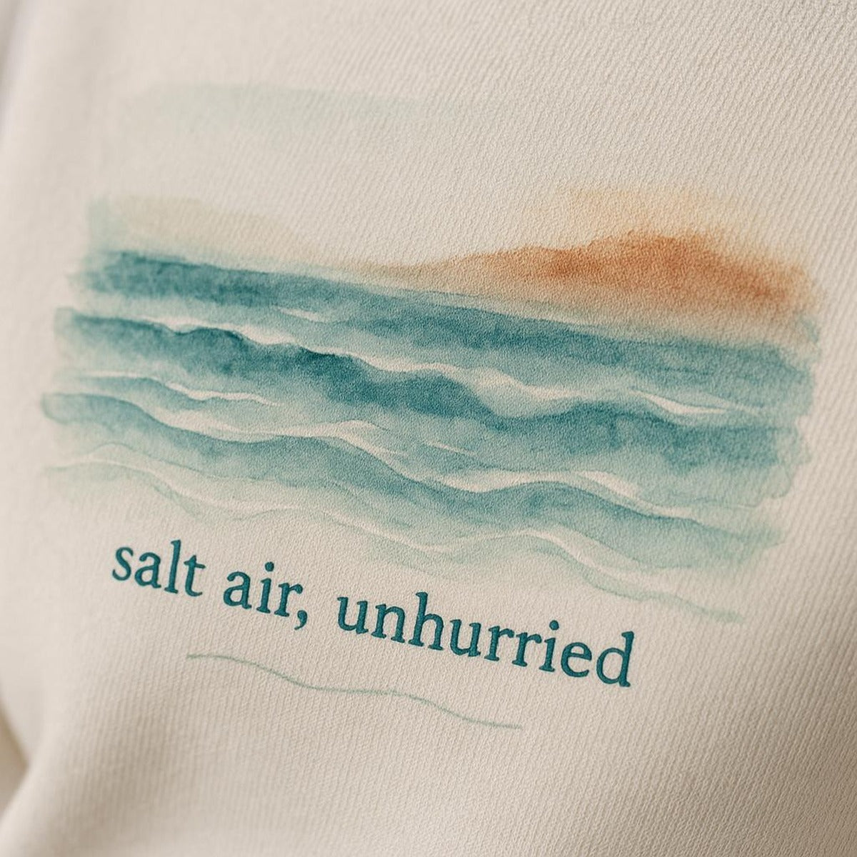 Close-up of the subtle tonal slow down coastal motif embroidered on the cuff