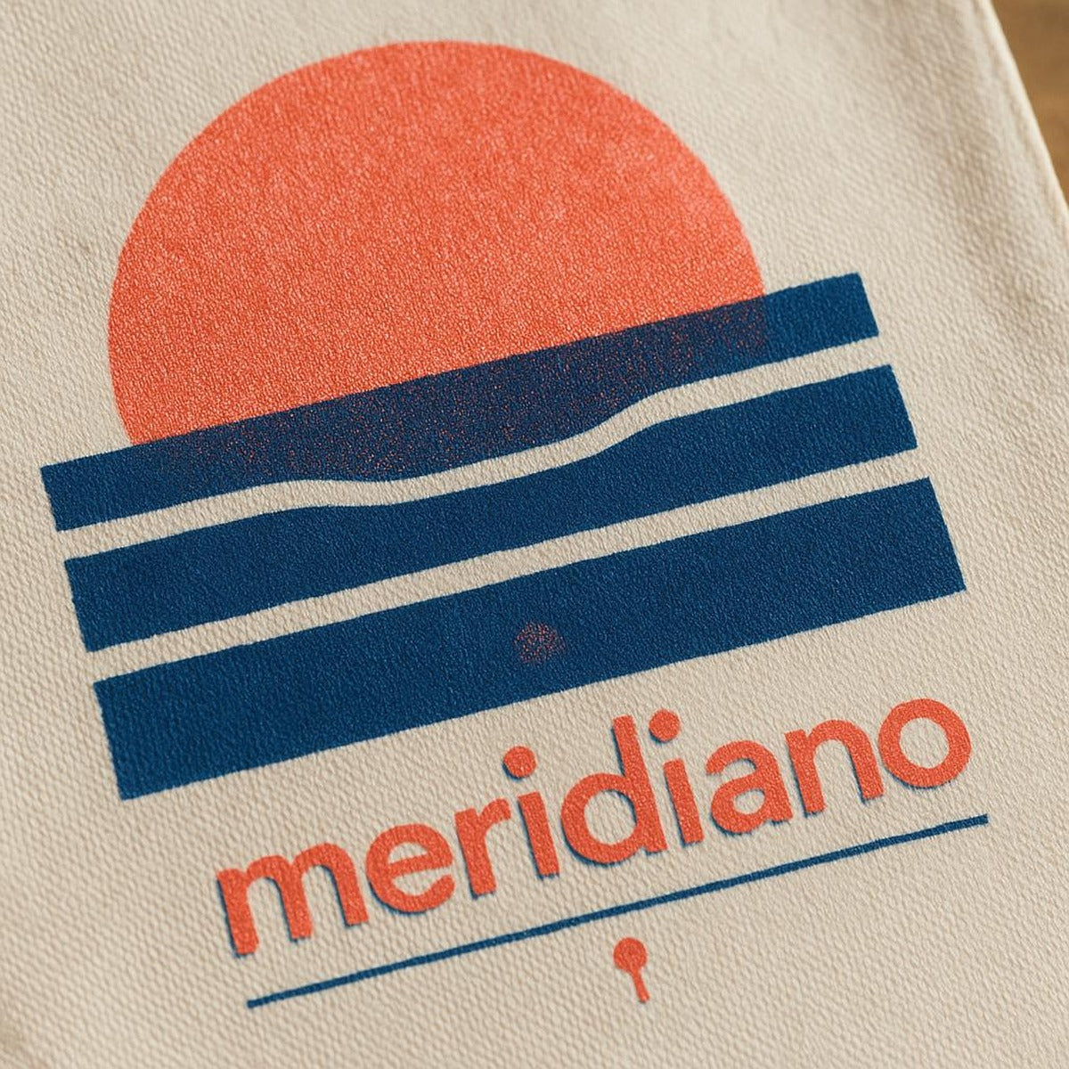 Close-up of the tiny tonal embroidered coastal marker stitched near the base of the tote