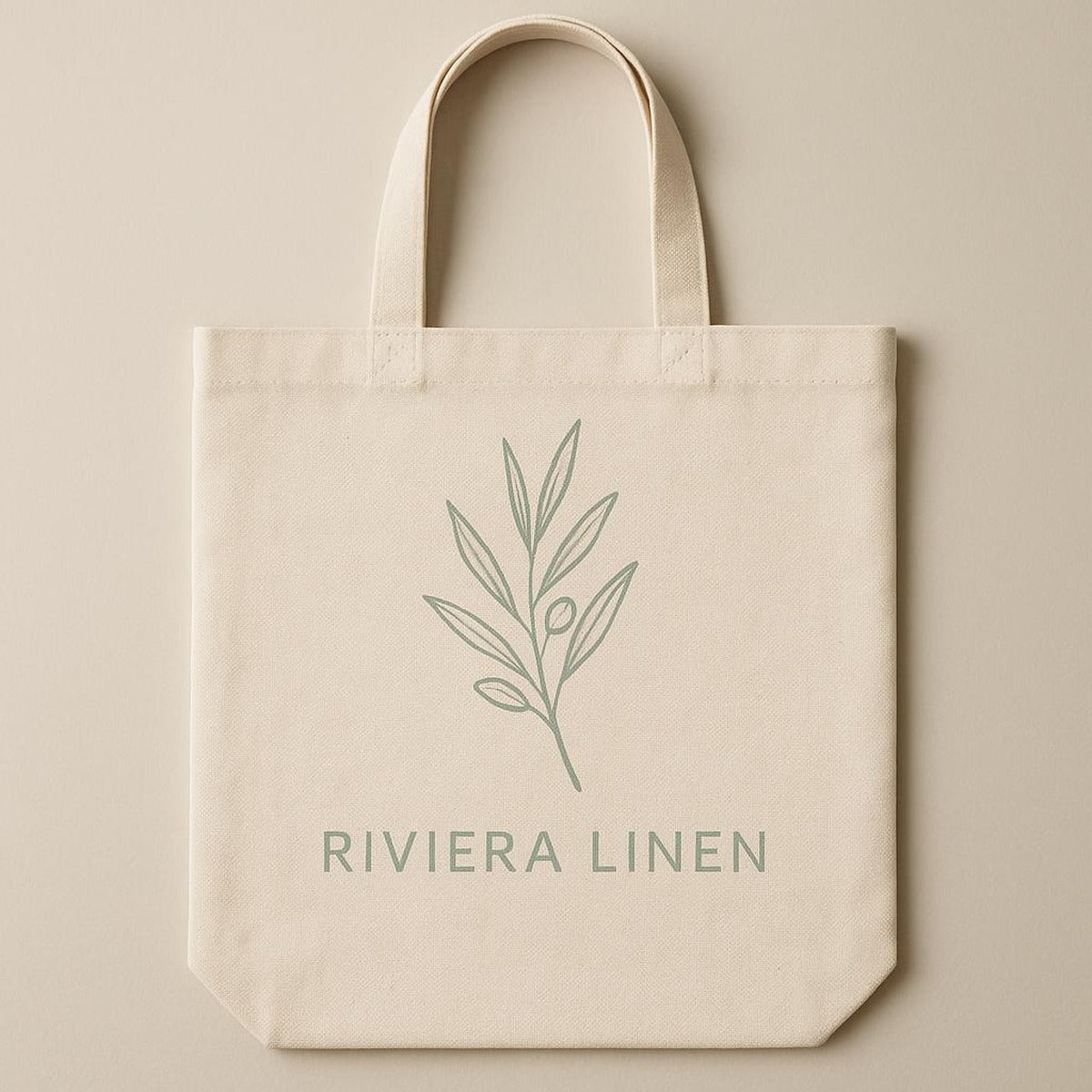 Detail of reinforced cotton webbing handles and neat stitching on the natural canvas tote