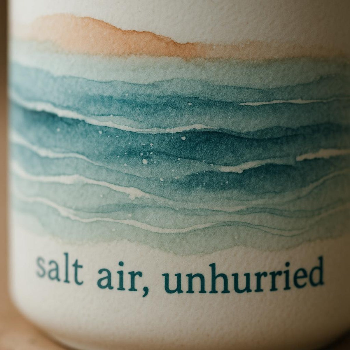 Close-up of the semi-matte glaze and tonal seaside print near the mug rim