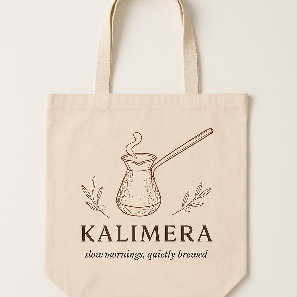 Natural cotton canvas tote bag printed with a copper cezve coffee pot illustration, shown flat against a neutral background