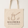 Natural cotton canvas tote bag printed with a copper cezve coffee pot illustration, shown flat against a neutral background