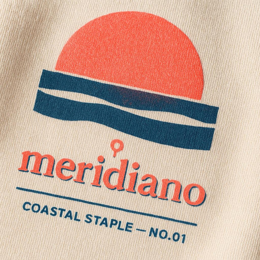 Close-up of tiny tonal embroidered coastal marker stitched at the sweatshirt hem