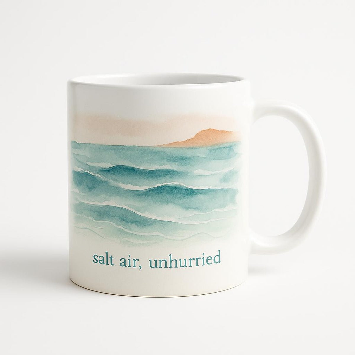 Sea-glass green ceramic mug with subtle tonal coastal slow down motif on a pale table