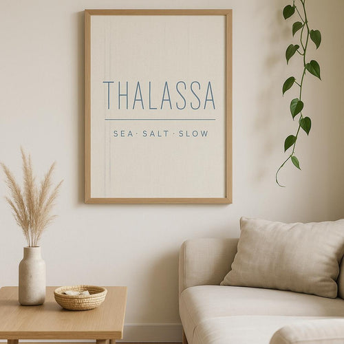 Coastal bathroom wall with the Thalassa hammam robe poster above a freestanding tub