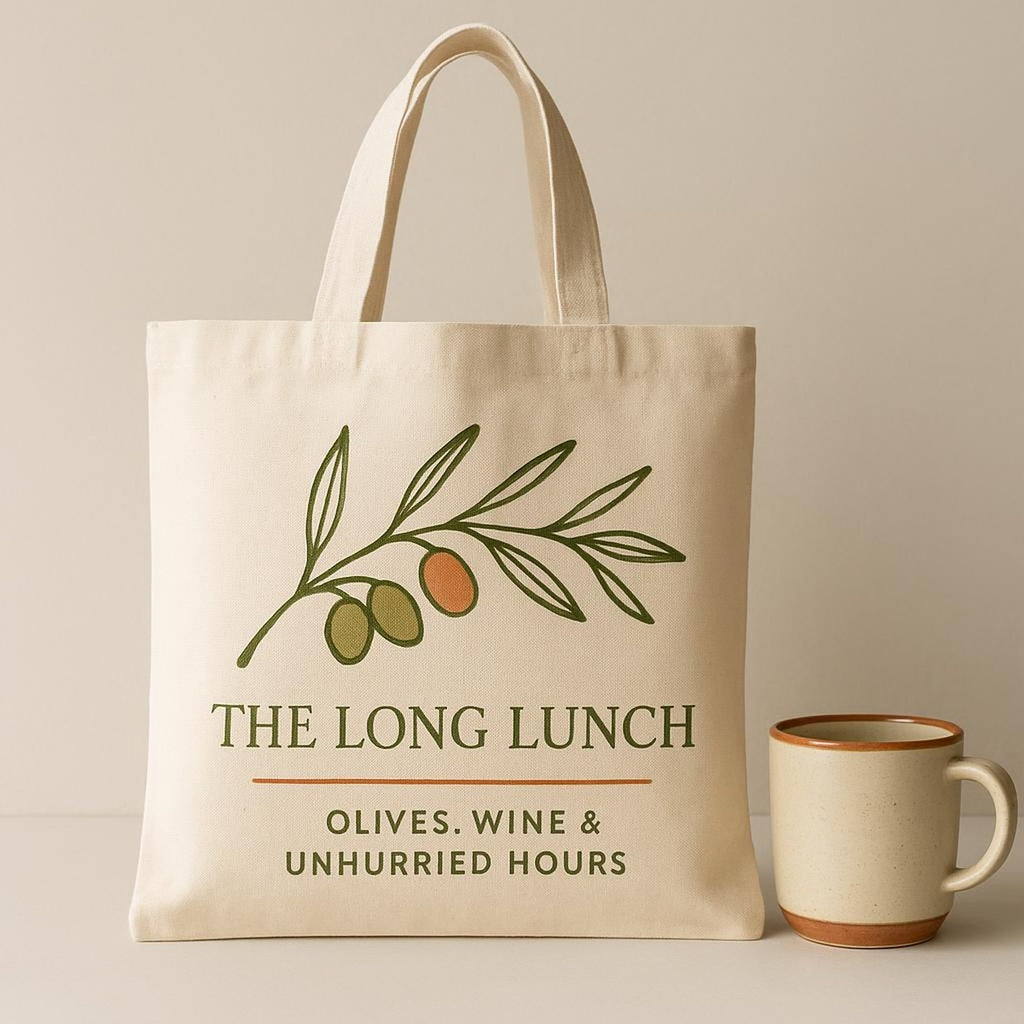 Tote bag held open to show its roomy unlined interior with a bottle and bread inside
