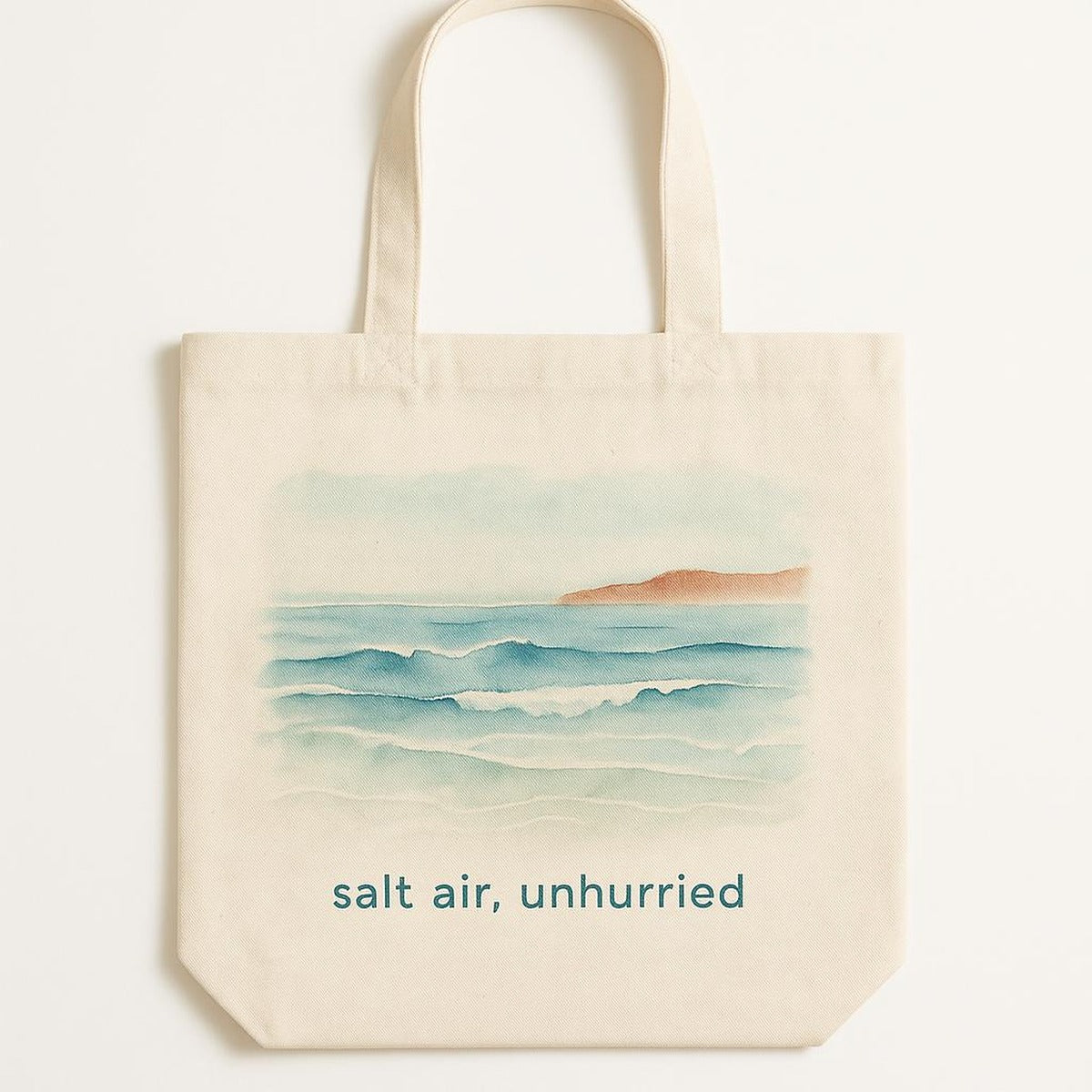 Hero shot of a sea-glass green canvas tote bag with a subtle tonal slow down coastal motif near the base