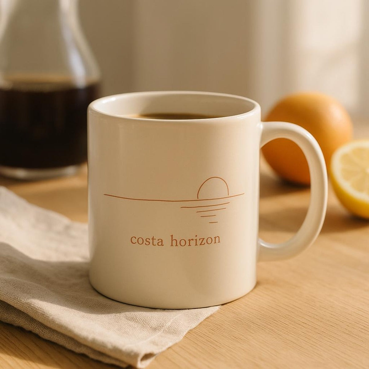 Costa Horizon mug on a sunlit Mediterranean terrace table beside a linen napkin and morning coffee