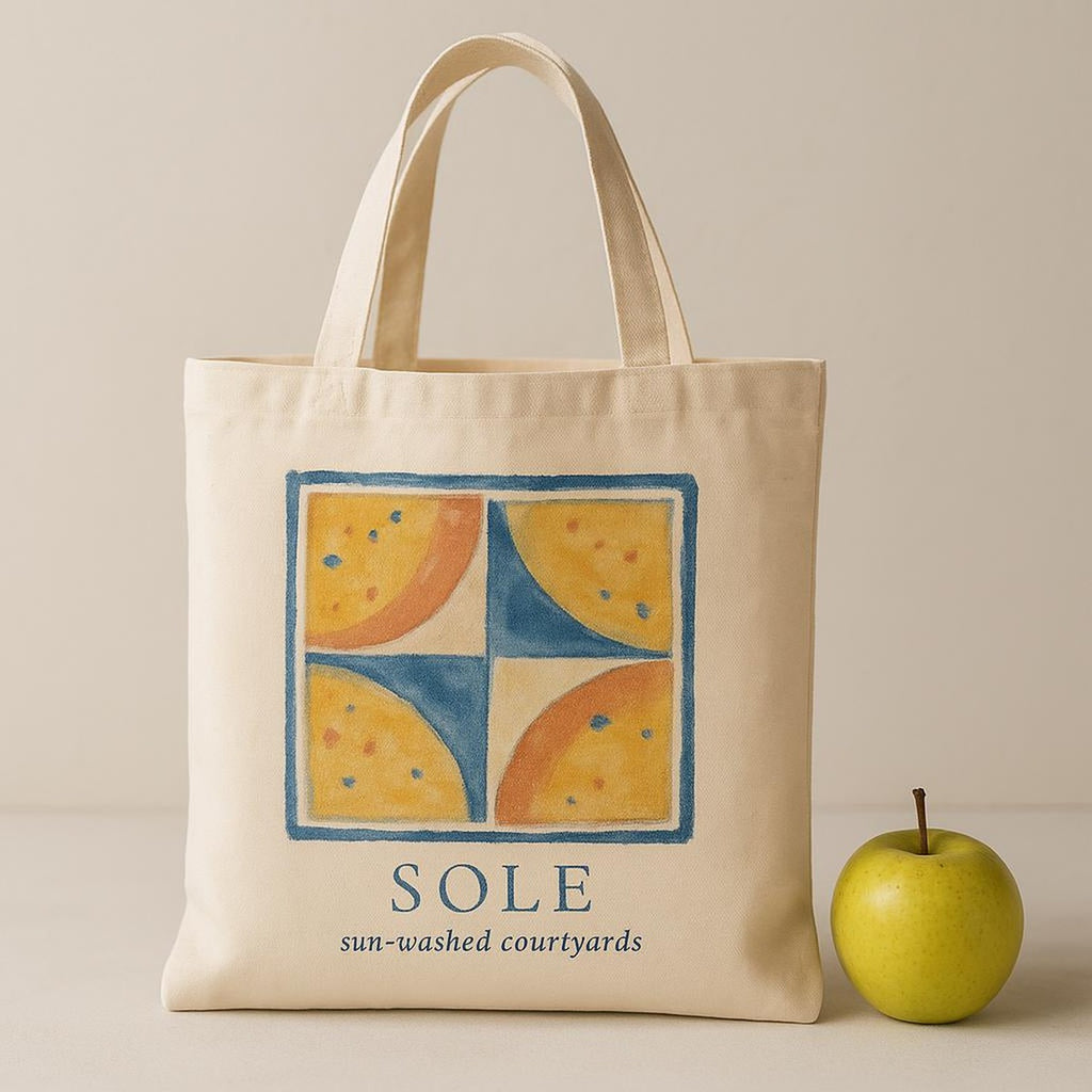Scale image showing the tote held in hand, filled with fresh bread, flowers and a rolled towel
