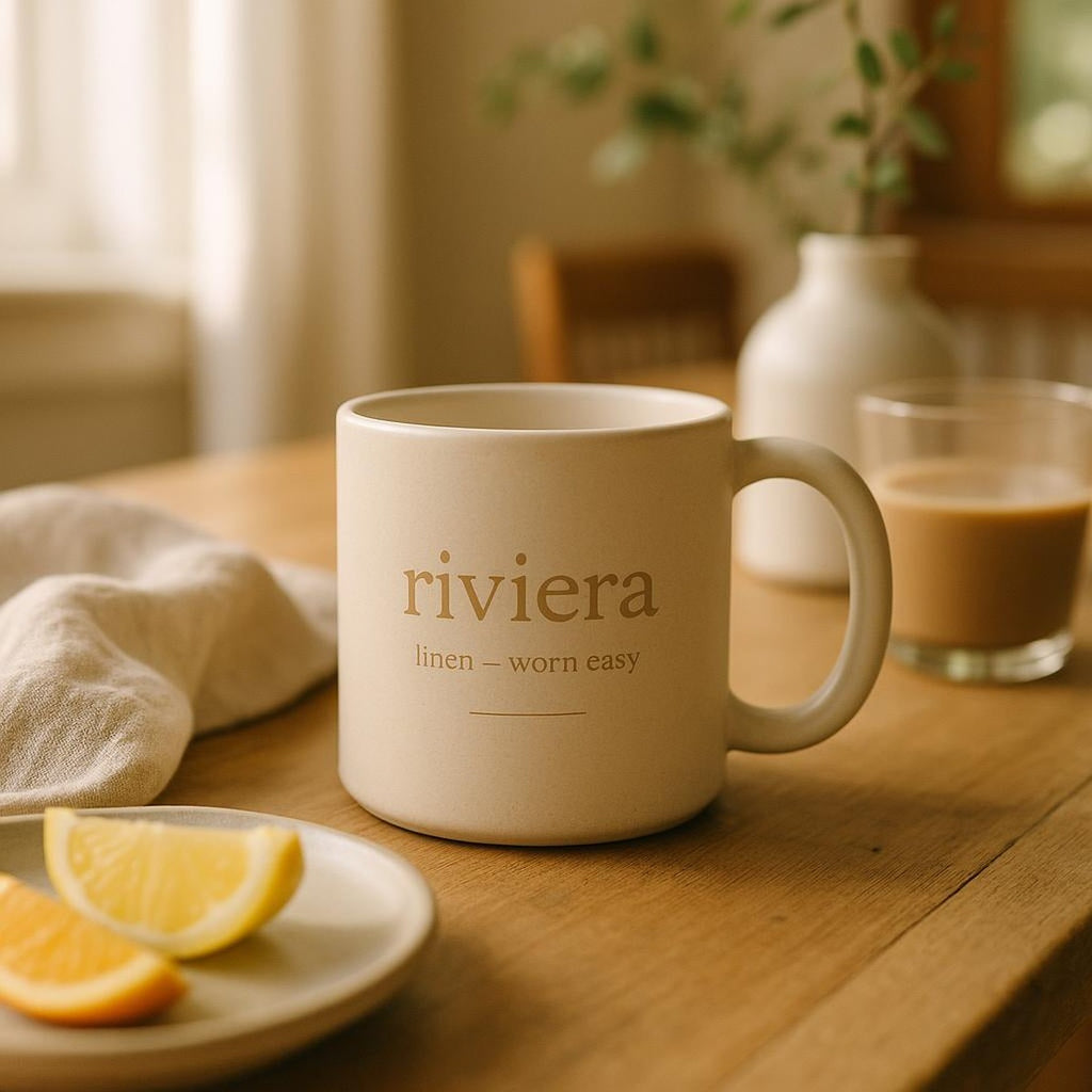 Mug filled with coffee resting on a natural wood shelf in a coastal Mediterranean kitchen