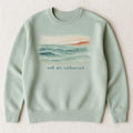 Sea-glass green loopback hoodie laid flat showing relaxed fit and double-lined hood