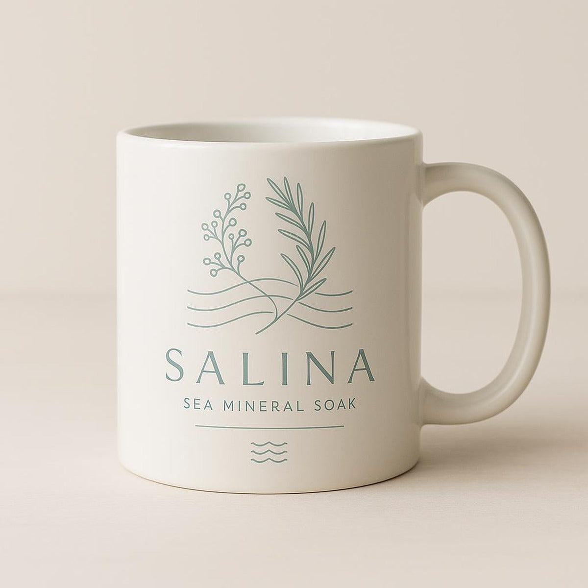 The coastal mug styled on a bright kitchen shelf with ceramics and greenery