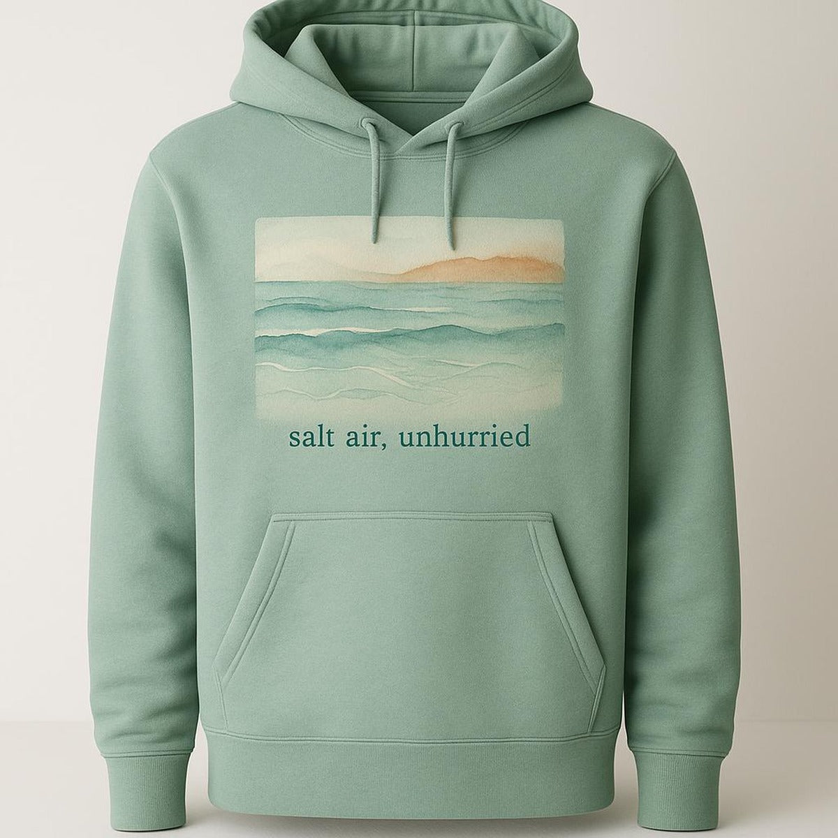 Sea-glass green heavyweight loopback hoodie shown flat on a pale sandy background