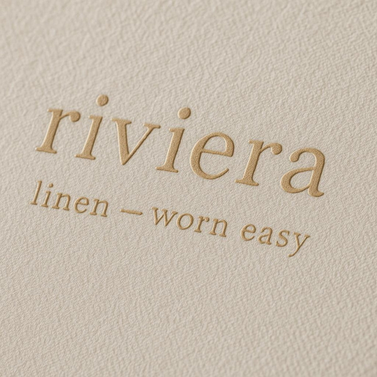 Close-up detail of the matte paper texture and soft sage and sand tones of the trouser illustration