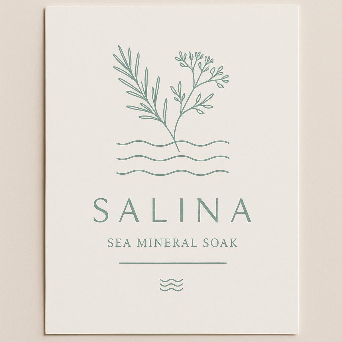 Salina Sea Mineral Soak print in a brass frame on a neutral bedroom wall above a reading chair