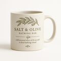 Sea green and salt white ceramic mug with olive branch and coastal design on a plain background