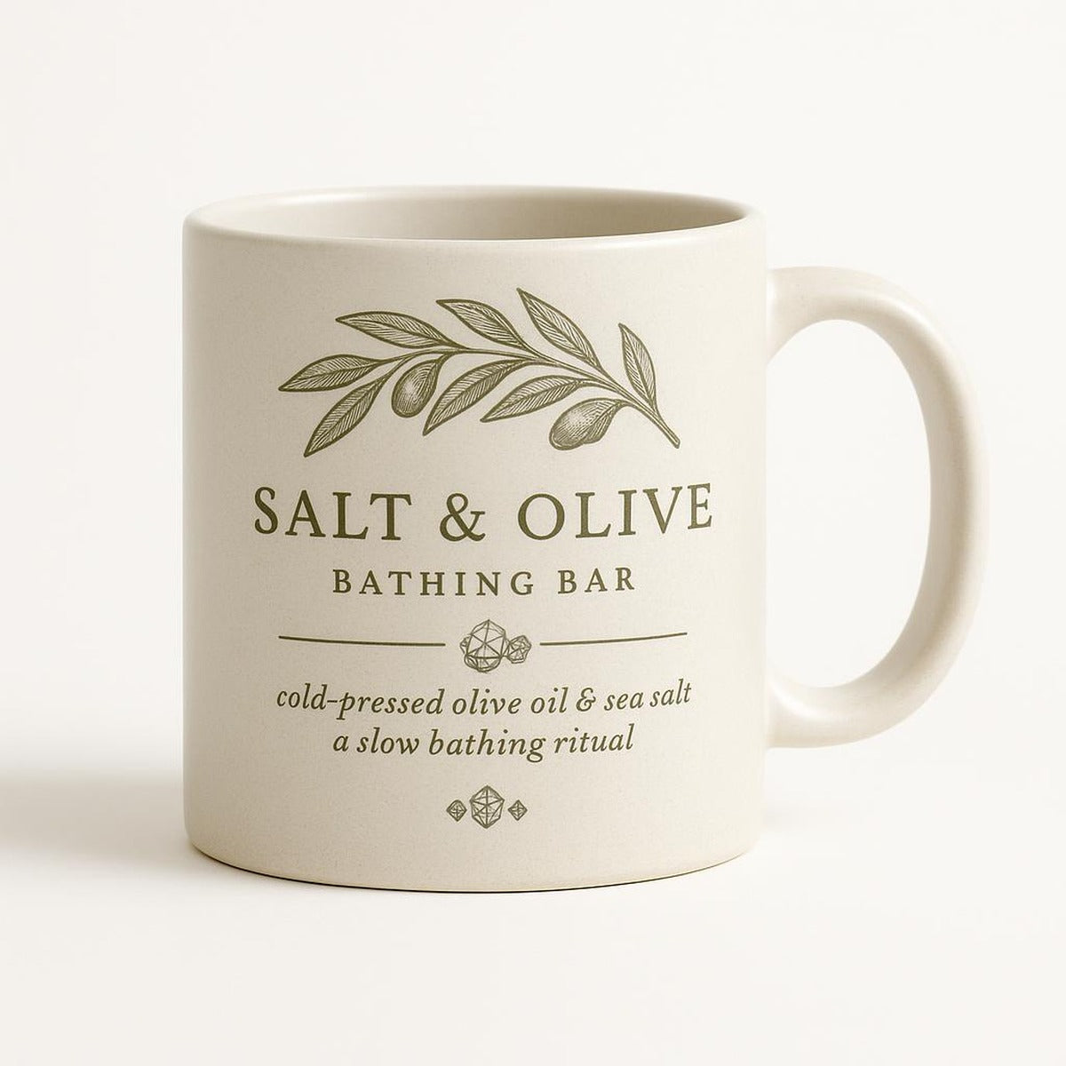 Sea green and salt white ceramic mug with olive branch and coastal design on a plain background