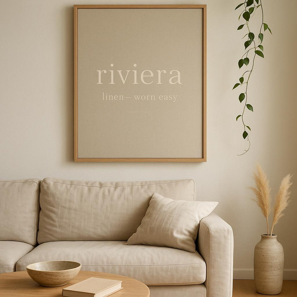 Lifestyle view of the linen trouser poster framed above a wooden dresser in a sunlit coastal bedroom
