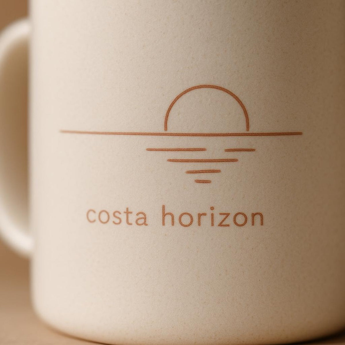 Close-up of the minimal sun and sea line print on the smooth glossy glaze of the mug