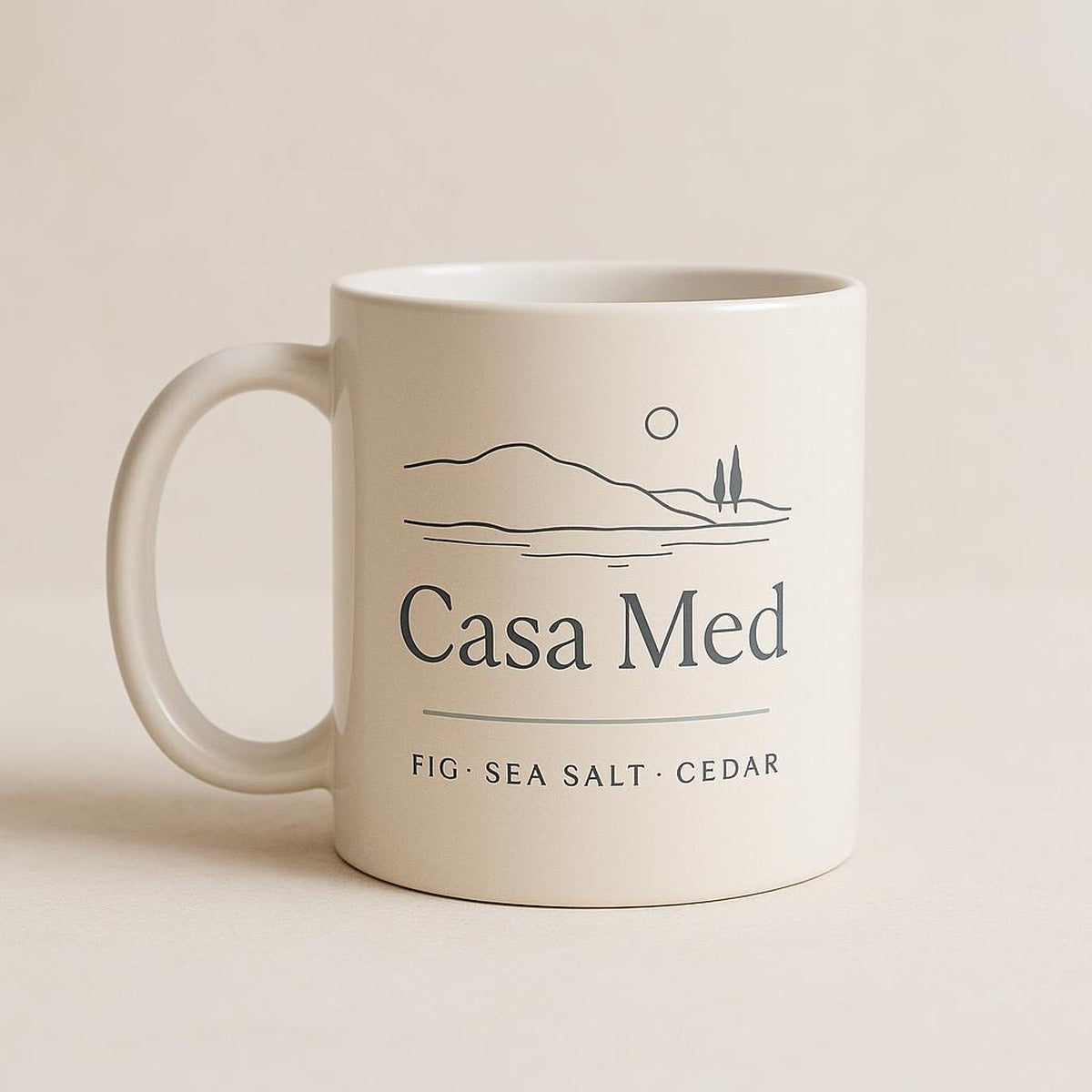 Overhead view of the Casa Med mug of tea on a wooden table with a book
