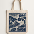 Stone-coloured stonewashed linen tote bag with tan handle tabs shown flat against a neutral background