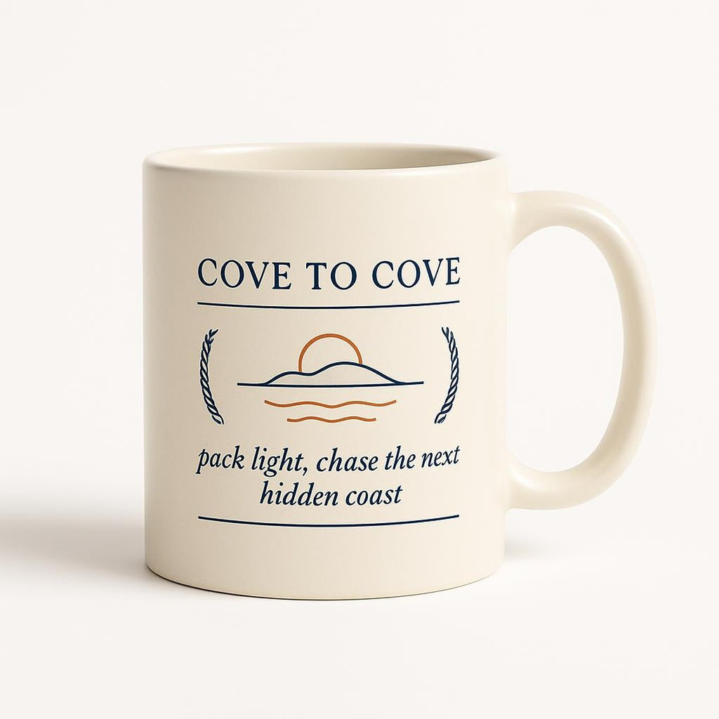 Sea blue ceramic mug with Cove-to-Cove coastal escape artwork on a white background