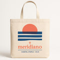 Sun-faded sand cotton canvas tote bag standing upright with flat base and wide shoulder straps