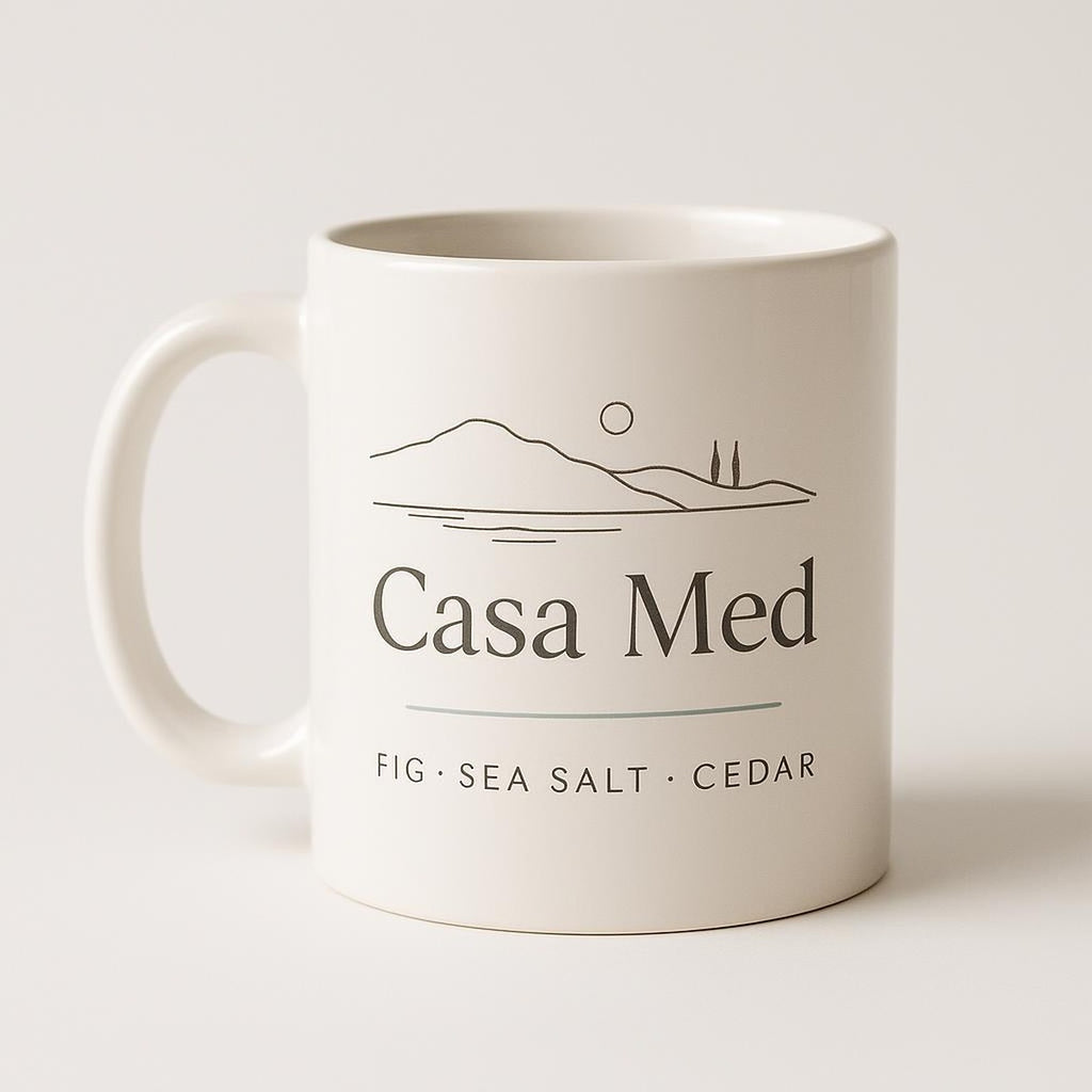 Hand-glazed terracotta ceramic mug with rounded handle on a pale linen surface