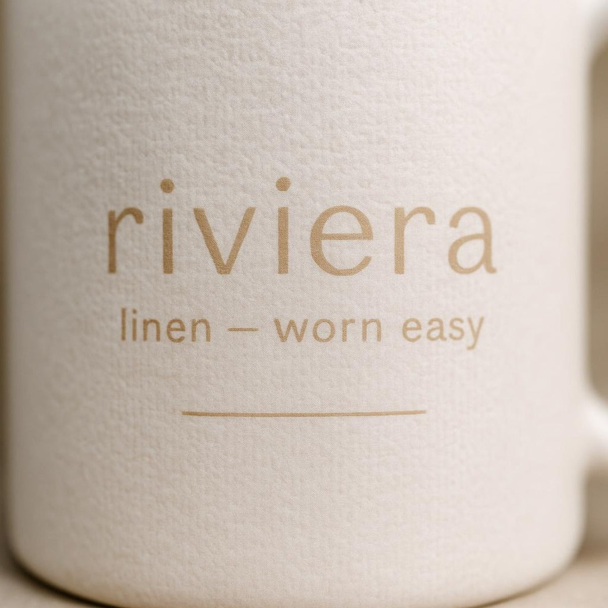 Close-up of the stonewashed linen texture and drawstring detail on the mug glaze