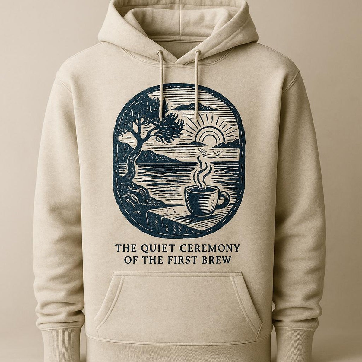 Folded hoodie styled on a rustic wooden table with a coffee scoop and bag clip in a coastal kitchen setting