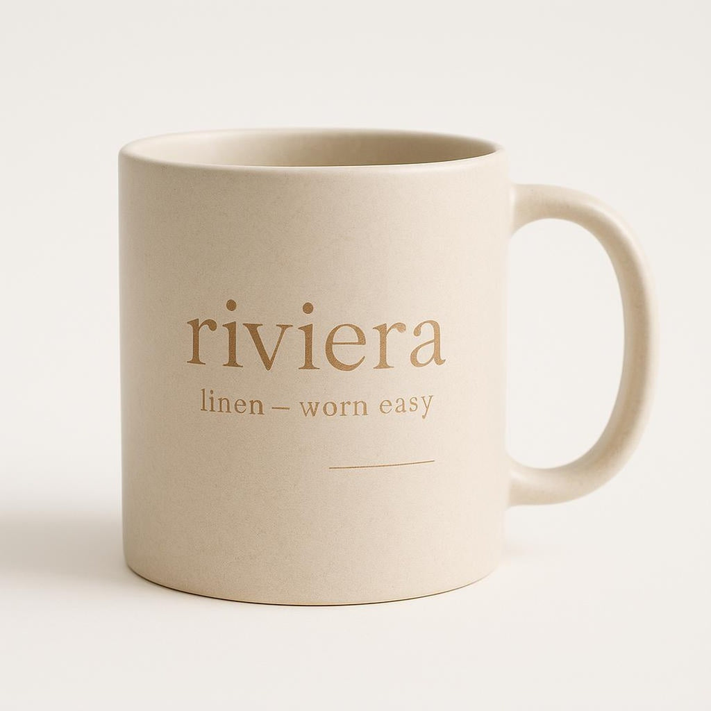 Off-white ceramic mug with sand-toned linen-inspired design on a neutral background