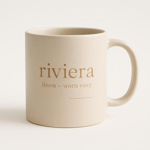 Off-white ceramic mug with sand-toned linen-inspired design on a neutral background