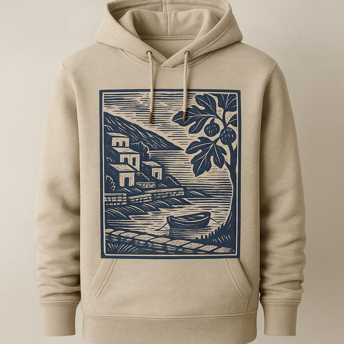 Folded hoodie styled on a wooden kitchen counter beside a linen apron and ceramics